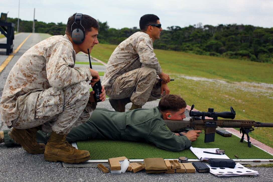 A reconnaissance Marine takes part in a timed shooting drill while marksmanship instructors watch where his shots hit during a three-week maritime raid force urban sniper course at Camp Schwab April 14. The instructors with Special Operations Training Group, III MEF Headquarters Group, III MEF, judged the sniper with 31st MEU, on his speed and accuracy while engaging the targets.