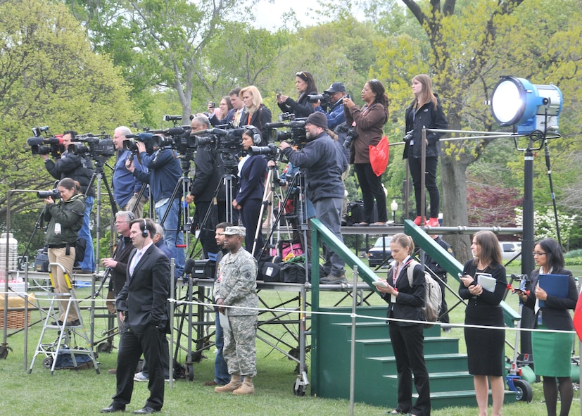 The White House Press Corps gathers on the South Lawn to witness Sidewinder's perfomance, April 11.  Sidewinder, the rock element of the 571st Air National Guard Band of the Central States, was invited by Mrs. Michelle Obama and Dr. Jill Biden to perform for the first anniversary of their Joint Forces Initiative.  Sidewinder is based at the 131st Bomb Wing – Lambert Air National Guard Base-Saint Louis. (Photo by Senior Master Sgt. Mary-Dale Amison)