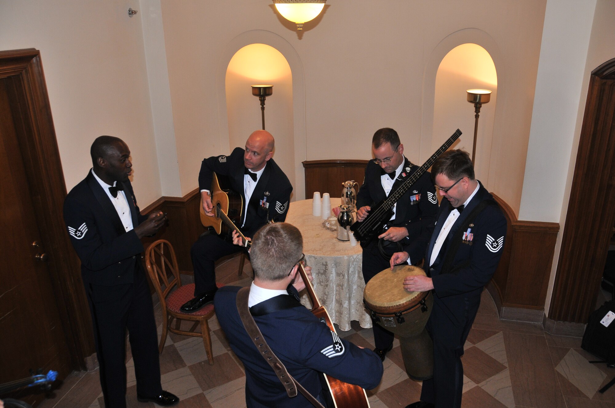 Vocalist Staff Sgt. Brian Owens, guitarist Technical Sgt. Paul Holzen, bassist Technical Sgt. John Cavanaugh, percussionist Technical Sgt. Kevin Maret, and guitarist Devin Larue jam in The White House "Green Room." April 11.  Sidewinder, the rock element of the 571st Air National Guard Band of the Central States, was invited by Mrs. Michelle Obama and Dr. Jill Biden to perform on the South Lawn for the first anniversary of their Joint Forces Initiative.  Sidewinder is based at the 131st Bomb Wing – Lambert Air National Guard Base-Saint Louis. (Photo by Senior Master Sgt. Mary-Dale Amison)
