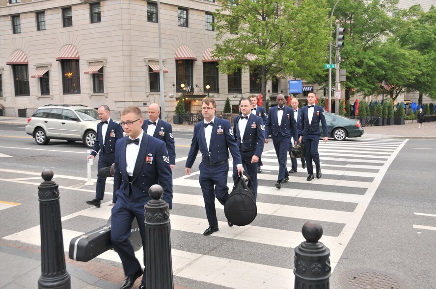 Sidewinder band members walk across Pennsylvania Avenue to the White House for their performance, April 11.  Sidewinder, the rock element of the 571st Air National Guard Band of the Central States, was invited by Mrs. Michelle Obama and Dr. Jill Biden to perform on the South Lawn for the first anniversary of their Joint Forces Initiative.  Sidewinder is based at the 131st Bomb Wing – Lambert Air National Guard Base-Saint Louis. (Photo by Senior Master Sgt. Mary-Dale Amison)