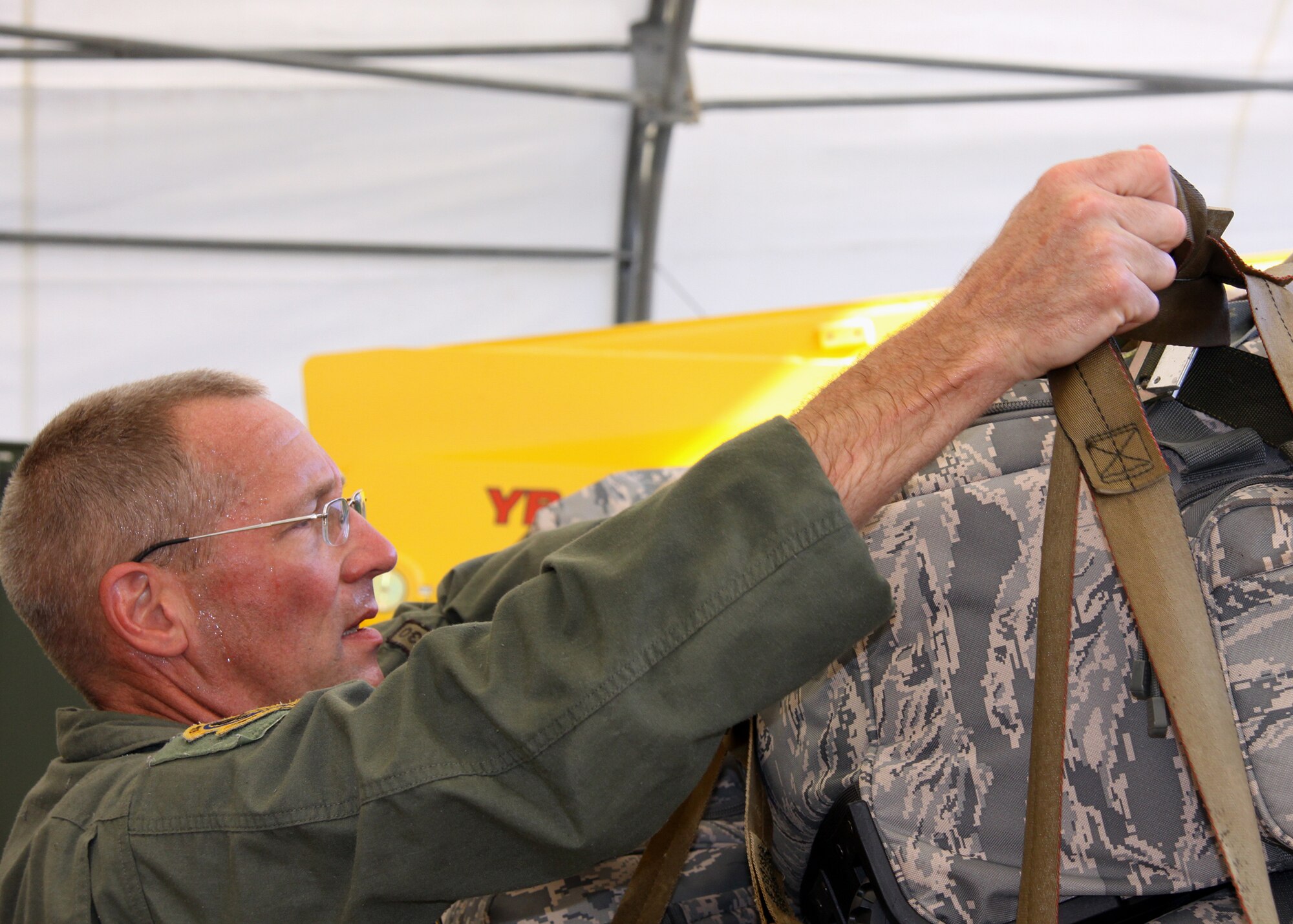 Senior Master Sgt. Archie Branton, 758th loadmaster superintendent, secures 
the top cargo netting on April 13, 2012, after he and several other loadmasters 
built the baggage pallet in preparation for the 'Coronet Oak' redeployment. 
Loadmasters traditionally make a friendly wager on the weight of the cargo 
prior it to hitting the scale.  The pallet weighed in at 43,000 pounds, with 
 Branton correctly guessing the weight. (U.S. Air Force photo 
by Capt. Shawn M. Walleck/Released)
