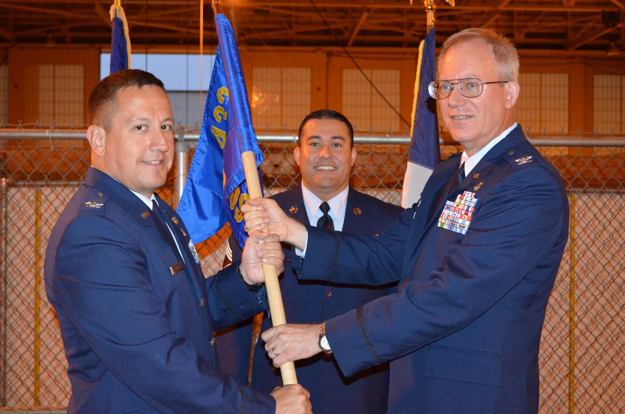 Col. Anthony Pena, left, accepts the guidon and command of the 433rd Medical Squadron from Col. William Blanchette, 433rd Medical Group commander on April 14, 2012, during an assumption of command ceremony at the Kelly Annex on Joint Base San Antonio-Lackland, Texas. (U.S. Air Force photo/Maj. Tim Wade)