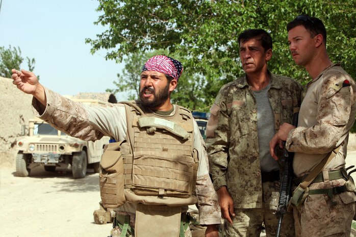 First Lt. Kevin J. Fitzsimmons, far right, a platoon commander with Weapons Company, 1st Battalion, 8th Marine Regiment, and an interpreter speak to the commander of the Afghan National Civil Order Police operating Patrol Base Virginia in Kajaki, April 14, 2012. Fitzsimmons, a native of Greenville, S.C., and his Marines patrolled several miles form PB Virginia to Forward Operating Base Whitehouse. (U.S. Marine Corps photo by Lance Cpl. Tyler Reiriz)