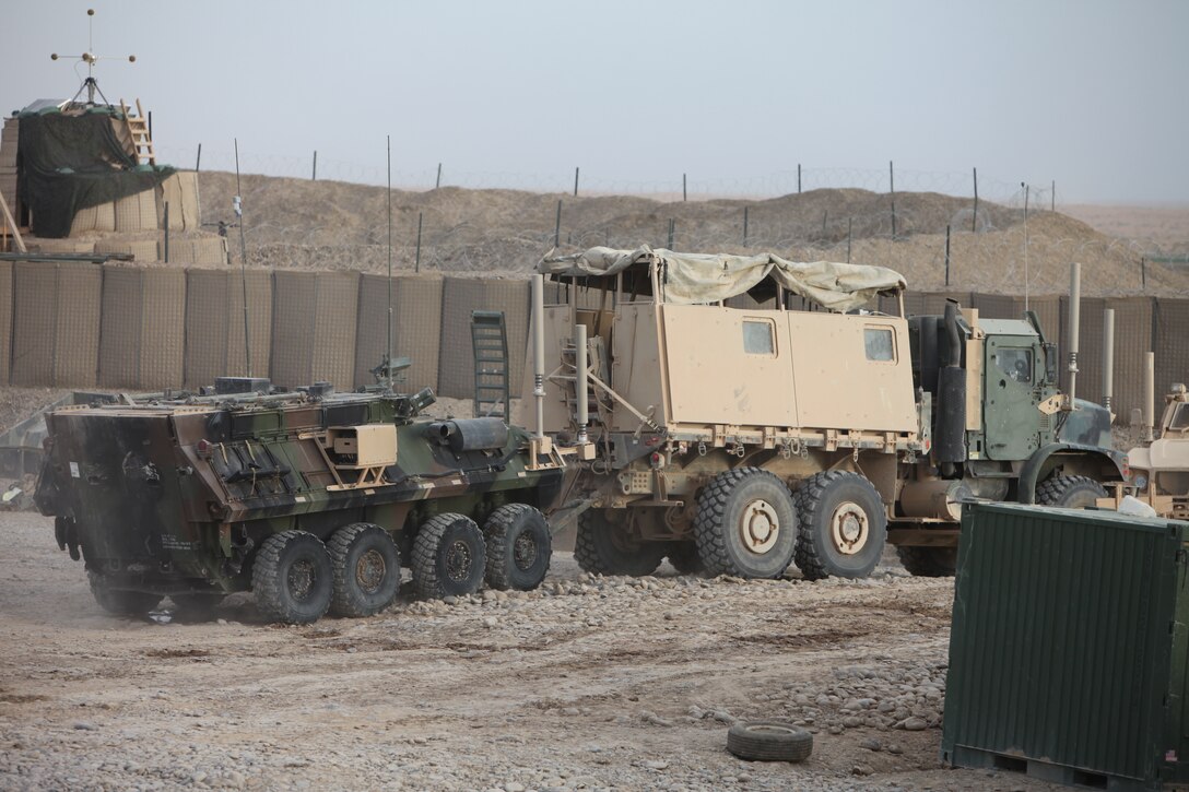 Marines with Combat Logistics Battalion 5, 1st Marine Logistics Group (Forward) tow a light armored vehicle at Forward Operating Base Payne, Afghanistan, April 14. As part of retrograde operations, CLB-5 removed seven LAVs from FOB Payne.