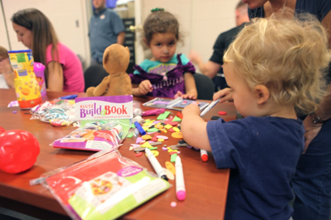 A class participant creates his very own book with the help of his family during the Klutz Build-a-Book Workshop held at the Harriotte B. Smith Library aboard Marine Corps Base Camp Lejeune, Sunday, a time set aside to recognize the country’s 1.9 million military children.