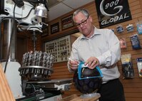 Steve Thompson, Skylark Bowling Center manager, measures for finger holes on a bowling ball April 5. The bowling center was named best in the Air Force for 2011. (U.S. Air Force photo/Robbin Cresswell)