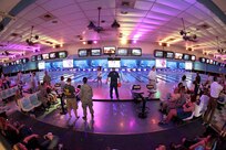 Air Force basic trainees, within two days of graduation, and their families enjoy cosmic bowling April 5 at the Skylark Bowling Center. The bowling center caters to the soon-to-be Airmen and their families during Air Force Basic Military Training graduation week. Innovations in customer service and new programs led to the Skylark’s recent selection as the best bowling center in the Air Force. (U.S. Air Force photo/Robbin Cresswell)