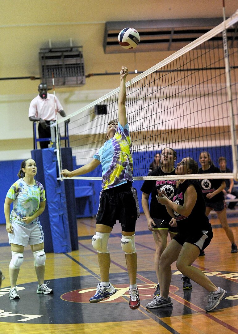 AFISRA’s Billie Rothwell looks on as Edith Coon dinks the ball over the net during the Joint Base San Antonio-Lackland women's intramural volleyball championship game Tuesday.
