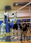 AFISRA’s Billie Rothwell looks on as Edith Coon dinks the ball over the net during the Joint Base San Antonio-Lackland women's intramural volleyball championship game Tuesday.