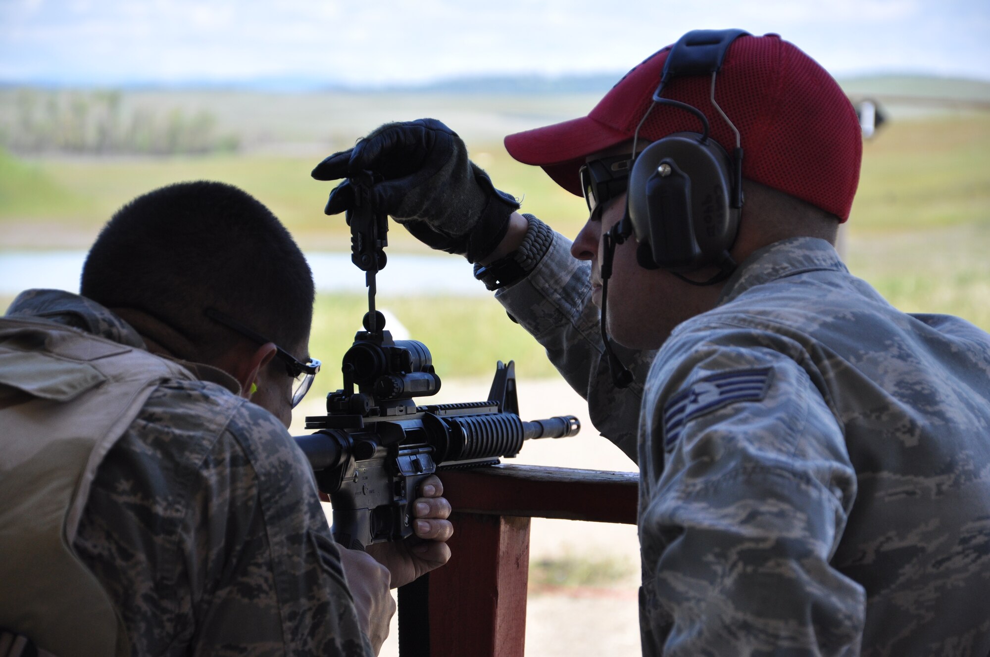 A 940th Security Forces Combat Arms Training and Maintenance instructor adjusts the M68 optics on an M-4 rifle during shooting practice at the firing range on Beale Air Force Base, Calif. Reservists with the 940th Wing engaged in the newly extended CATM course during their Unit Training Assembly, April 14-15, 2012. (U.S. Air Force Photo by Senior Airman Adam Hamar)