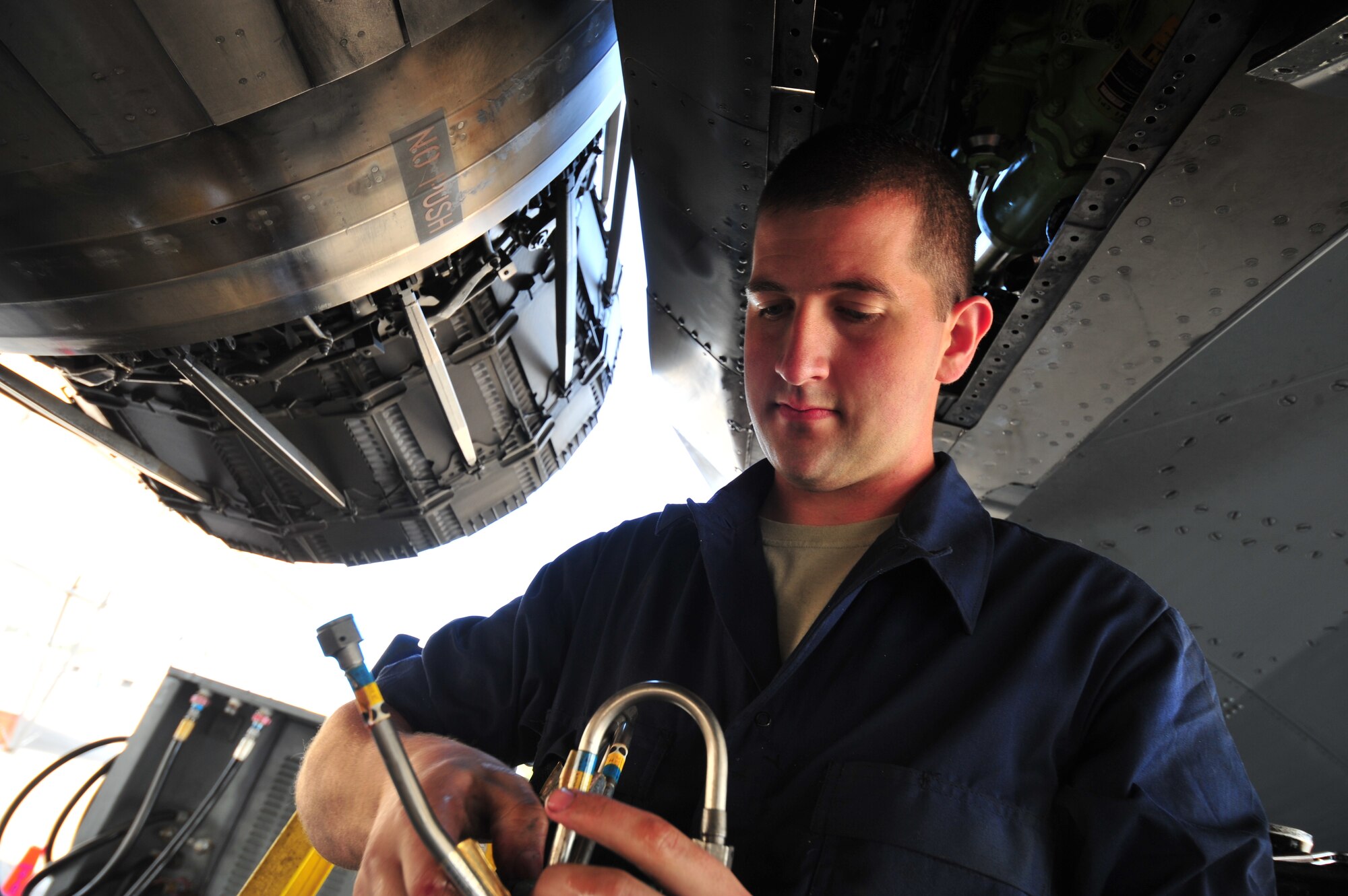 Senior Airman Adam Johnson inspects hydraulic lines before installing them April 13, 2012, at at Seymour Johnson Air Force Base, N.C. Airmen from the 4th Fighter Wing work together to prepare for Mustang Mayhem, a training mission to launch 70 F-15E Strike Eagles that will destroy more than 1,000 targets on bombing ranges across North Carolina to pay homage to their history in World War II. Johnson is an F-15E crew chief assigned to the 4th Aircraft Maintenance Squadron. (U.S. Air Force photo/Staff Sgt. Elizabeth Rissmiller)