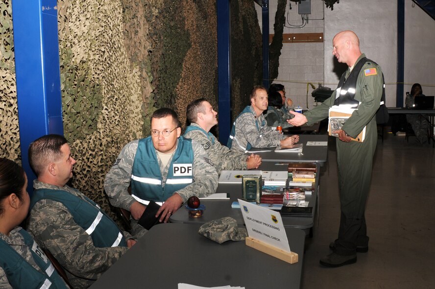 Airmen from the 161st Air Refueling Wing process a personnel deployment function line during an exercise April 14, 2012 at Phoenix Sky Harbor Air National Guard Base. The PDF line is simulated to prepare Airmen for a real-world experience. (Photo by Senior Airman Rashaunda Williams/Released)