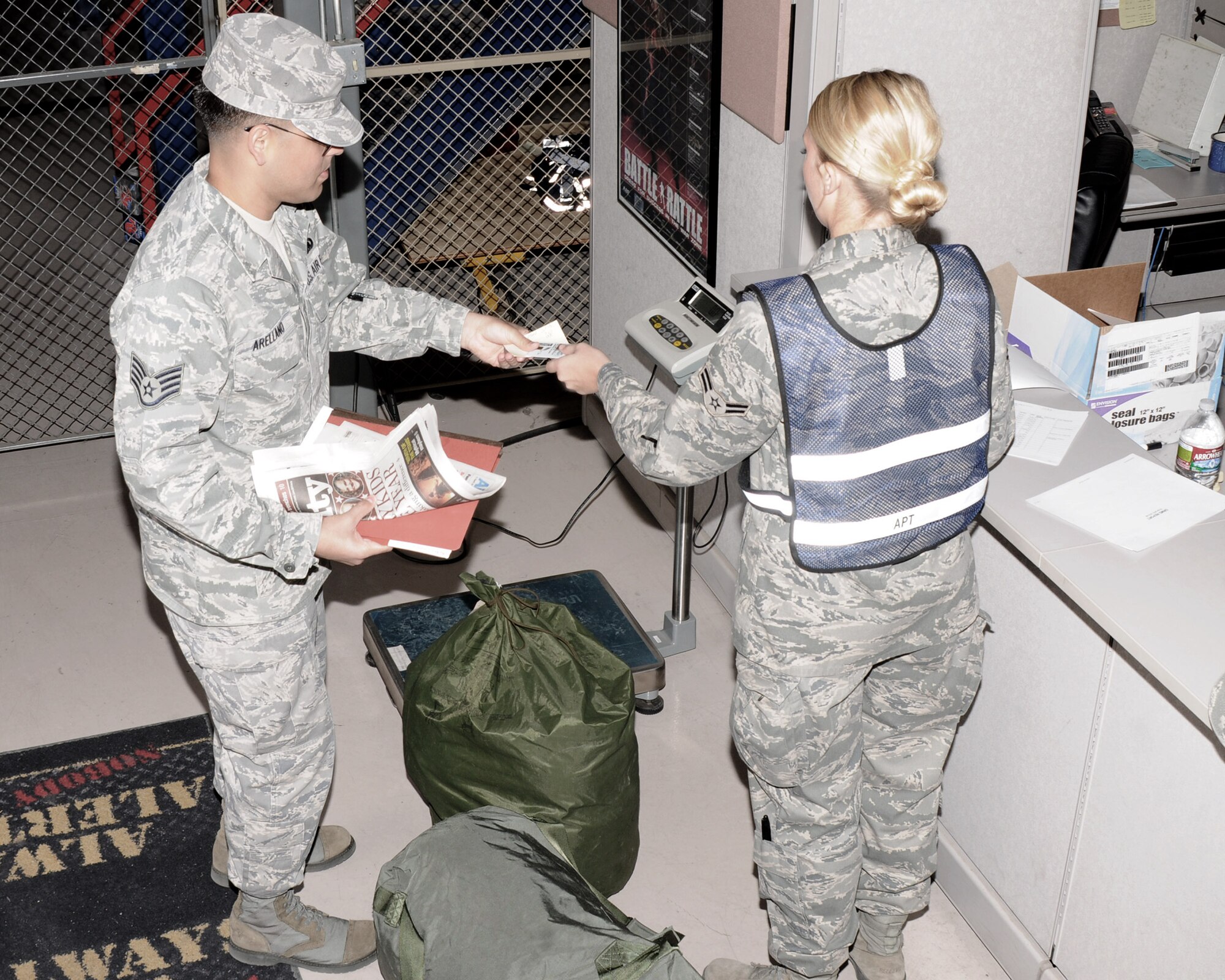 Airmen from the 161st Air Refueling Wing process a personnel deployment function line during an exercise April 14, 2012 at Phoenix Sky Harbor Air National Guard Base. The PDF line is simulated to prepare Airmen for a real-world experience. (Photo by Senior Airman Rashaunda Williams/Released)