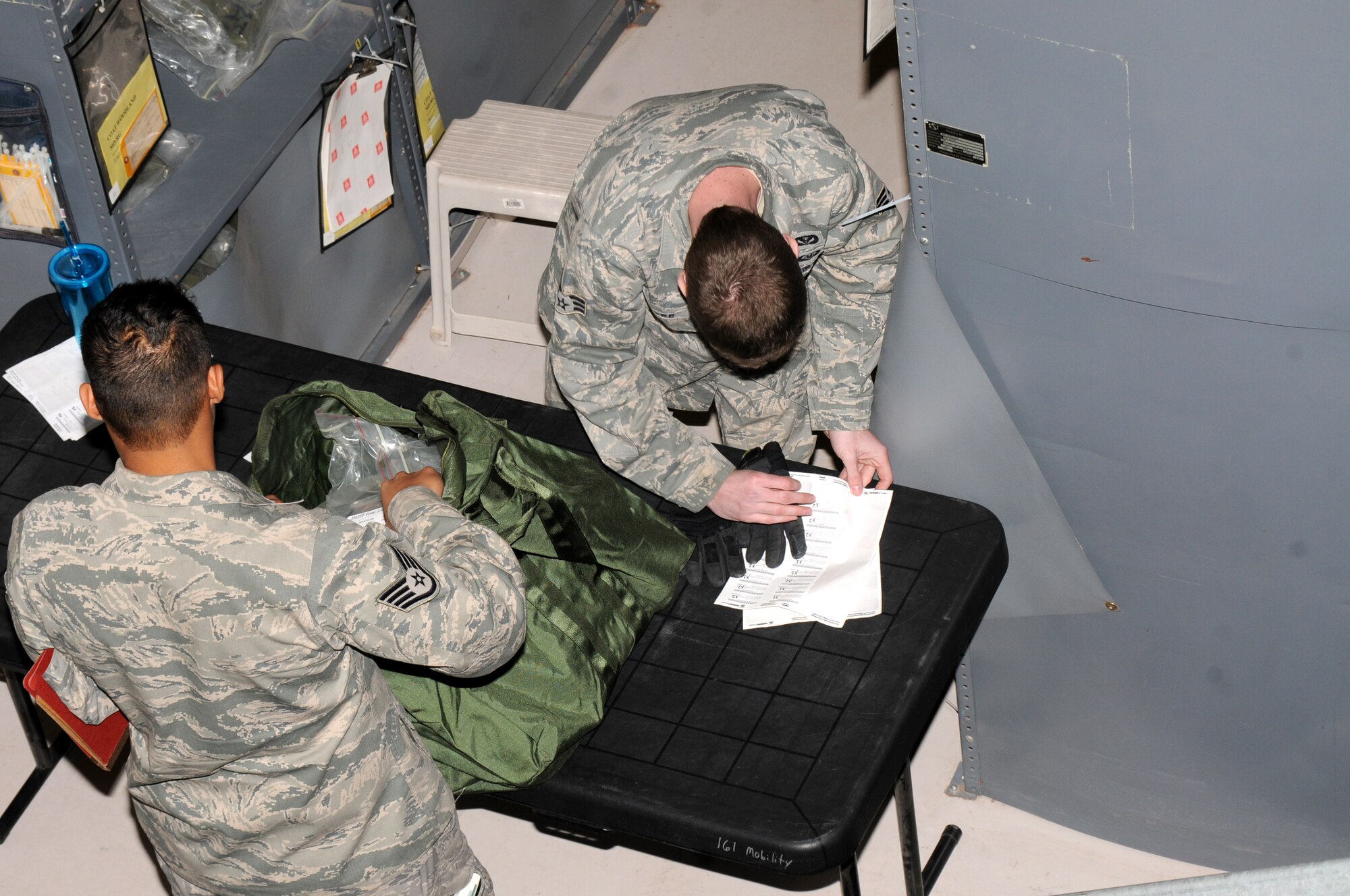 Airmen from the 161st Air Refueling Wing process a personnel deployment function line during an exercise April 14, 2012 at Phoenix Sky Harbor Air National Guard Base. The PDF line is simulated to prepare Airmen for a real-world experience. (Photo by Senior Airman Rashaunda Williams/Released)