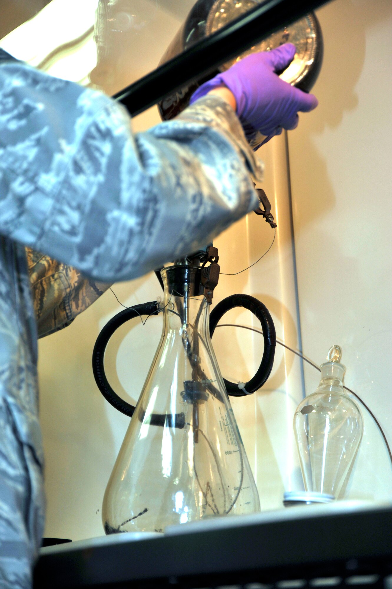 Senior Airman Christi Hilton, 403rd Logistics Readiness Squadron, pours a sample of JP-8 fuel into a large beaker in order to inspect the sample for impurities during a training module Apr. 14. The 403rd LRS and 41st Aerial Port Squadron shared job knowledge with Naval Expeditionary Logistics Regiment 4 battalions as part of a joint training exercise Apr. 12-17 at Keesler Air Force Base, Miss. (U.S. Air Force photo by Maj. Heather Newcomb)