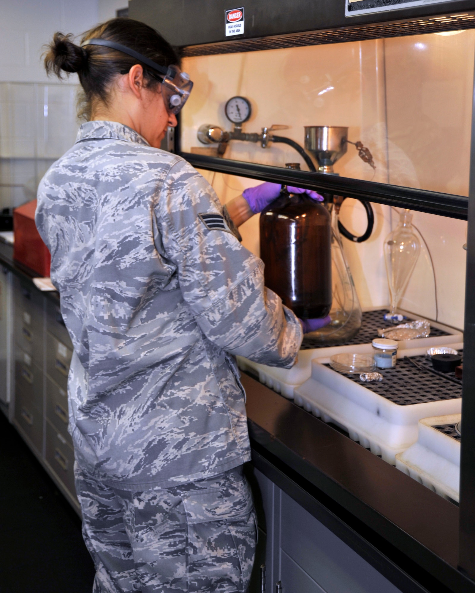 Senior Airman Christi Hilton, 403rd Logistics Readiness Squadron, prepares a sample of JP-8 fuel for inspection during a training module Apr. 14. The 403rd LRS and 41st Aerial Port Squadron shared job knowledge with Naval Expeditionary Logistics Regiment 4 battalions as part of a joint training exercise Apr. 12-17 at Keesler Air Force Base, Miss. (U.S. Air Force photo by Maj. Heather Newcomb)