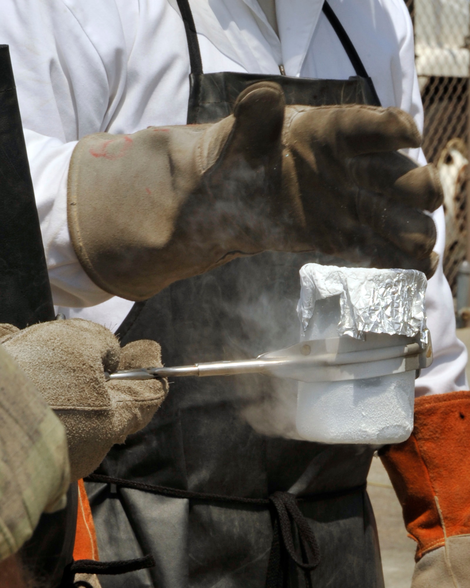 Tech. Sgt. Leren Curry,403rd Logistics Readiness Squadron, holds a sample of liquid oxygen taken from a LOX cart during a training module Apr. 14. Curry took the sample in order to check for impurities within the liquid oxygen. The 403rd LRS and 41st Aerial Port Squadron shared job knowledge with Naval Expeditionary Logistics Regiment 4 battalions as part of a joint training exercise Apr. 12-17 at Keesler Air Force Base, Miss. (U.S. Air Force photo by Maj. Heather Newcomb)