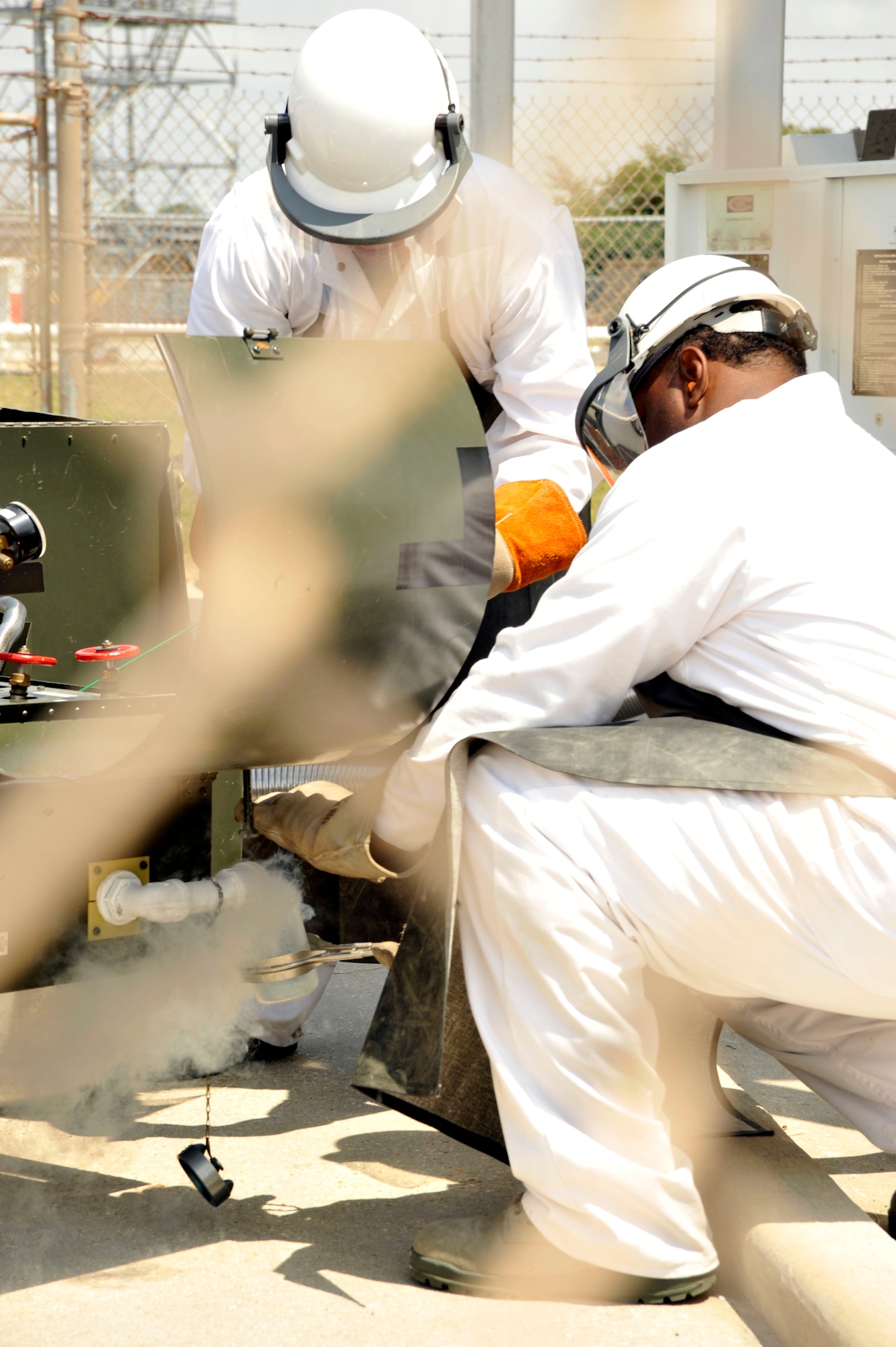 Staff Sgt. Michael McPherson and Tech. Sgt. Leren Curry, members of the 403rd Logistics Readiness Squadron, take a sample of liquid oxygen from a LOX cart, in order to check for impurities, during a training module Apr. 14. The 403rd LRS and 41st Aerial Port Squadron shared job knowledge with Naval Expeditionary Logistics Regiment 4 battalions as part of a joint training exercise Apr. 12-17 at Keesler Air Force Base, Miss. (U.S. Air Force photo by Maj. Heather Newcomb)