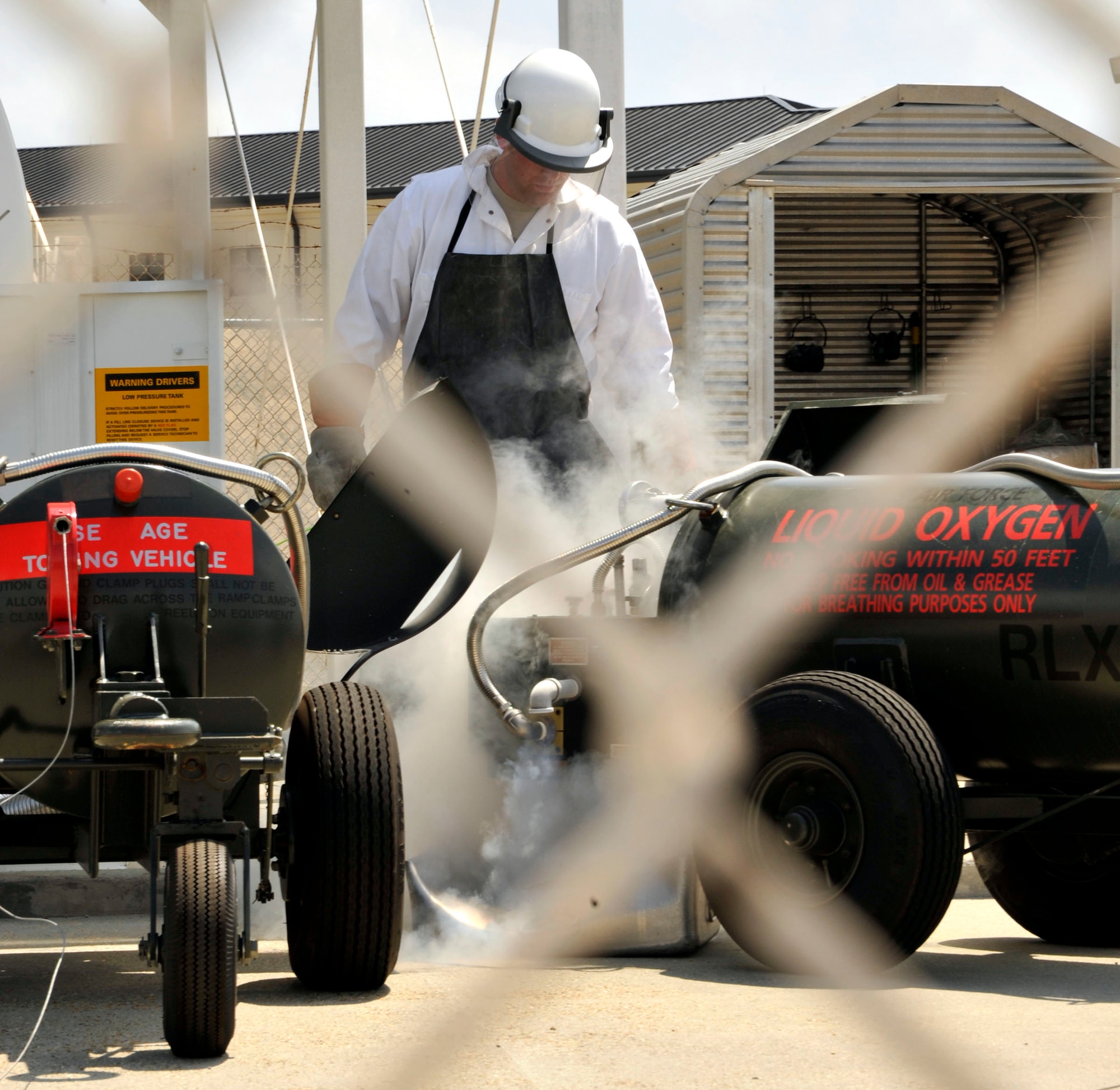 Staff Sgt. Michael McPherson, 403rd Logistics Readiness Squadron, monitors the transfer of liquid oxygen from the storage tank to a LOX cart during a training module Apr. 14. The 403rd LRS and 41st Aerial Port Squadron shared job knowledge with Naval Expeditionary Logistics Regiment 4 battalions as part of a joint training exercise Apr. 12-17 at Keesler Air Force Base, Miss. (U.S. Air Force photo by Maj. Heather Newcomb)