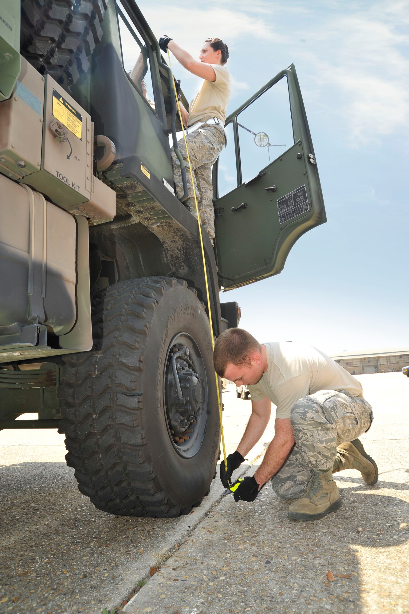 Senior Airman Sara House and Airman 1st Class Martin Guthrie measure the clearance height of a vehicle for load planning. House and Guthrie are members of the 41st Aerial Port Squadron and were conducting training Apr. 14 as part of a joint training exercise between the 41st APS, the 403rd Logistics Readiness Squadron, and the Naval Expeditionary Logistics Regiment 4 held at Keesler Air Force Base, Miss. (U.S. Air Force illustration by Maj. Heather Newcomb)