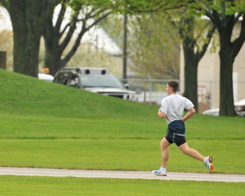 Airman 1st Class Robert Miles, 115th Force Support Squadron, runs on the Truax Field track as part of his annual physical fitness assessment April 15. Miles finished with a time of 7:59 which put him in the "Excellent" category with an overall score of 99.5 percent. Miles is also training for the National Guard Marathon in Lincoln, Neb., for a chance to make the National Guard Marathon Team which travels around the country to compete. Wisconsin Air National Guard photo by Tech. Sgt. Jon LaDue 
