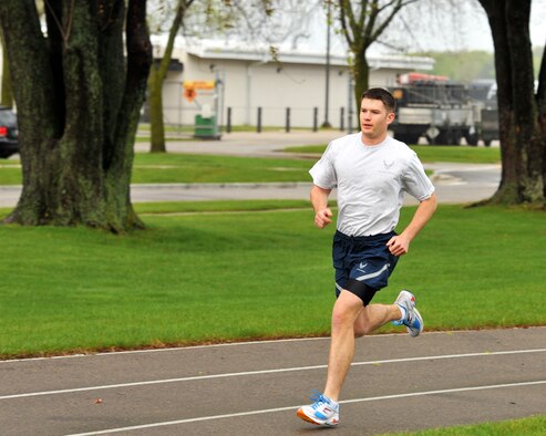 Airman 1st Class Robert Miles, 115th Force Support Squadron, runs on the Truax Field track as part of his annual physical fitness assessment April 15. Miles finished with a time of 7:59 which put him in the "Excellent" category with an overall score of 99.5 percent. Miles is also training for the National Guard Marathon in Lincoln, Neb., for a chance to make the National Guard Marathon Team which travels around the country to compete. Wisconsin Air National Guard photo by Tech. Sgt. Jon LaDue 
