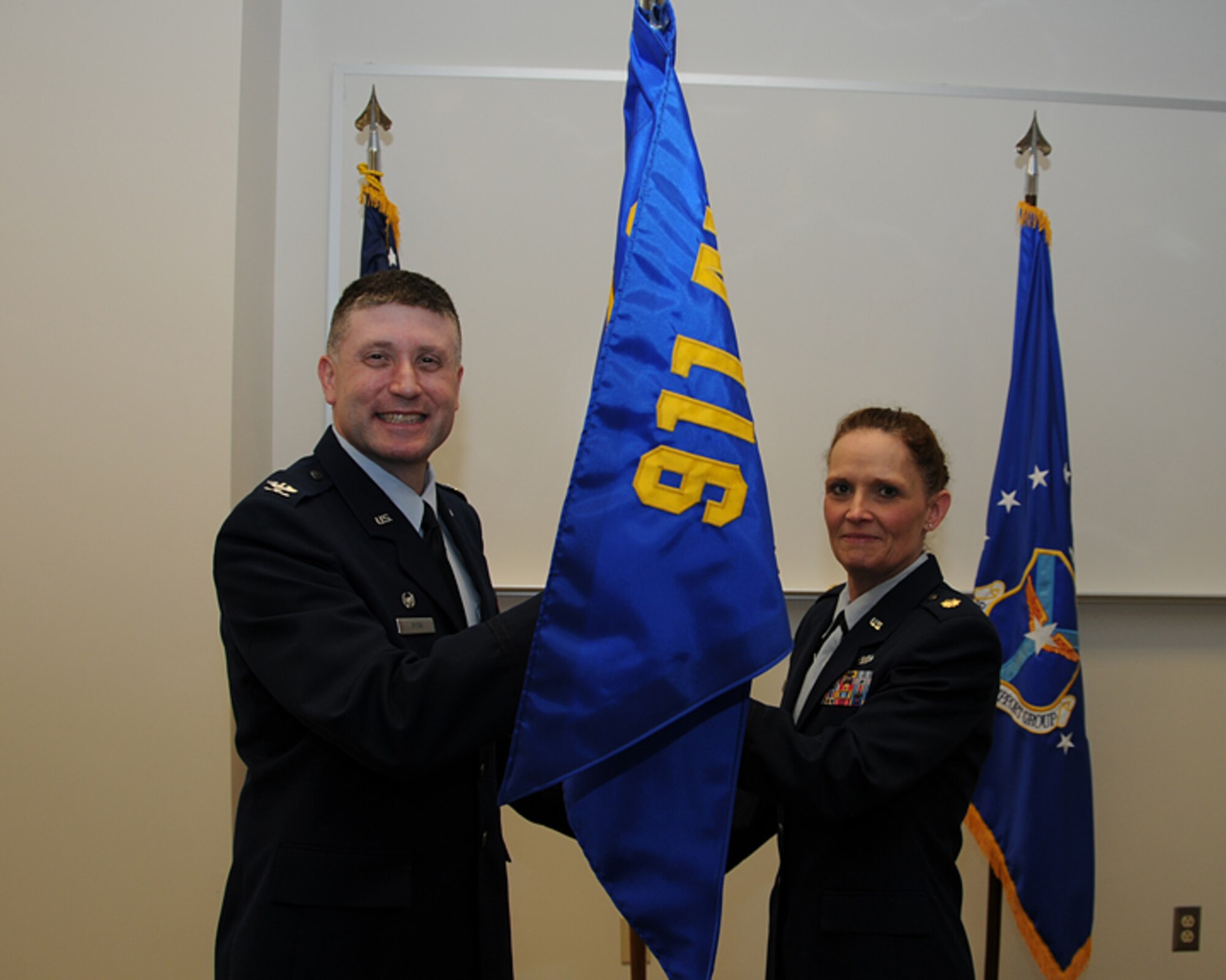 Maj. Tanaka Dunn, right, receives the 911th Logistics Readiness Squadron guidon from Col. Patrick Ryan, 911th Mission Support Group Commander, April 15, 2012. By receiving the guidon, Major Dunn assumes the duties as commander of the 911th LRS. (U.S. Air Force photo/Senior Airman Joshua J. Seybert/Released)