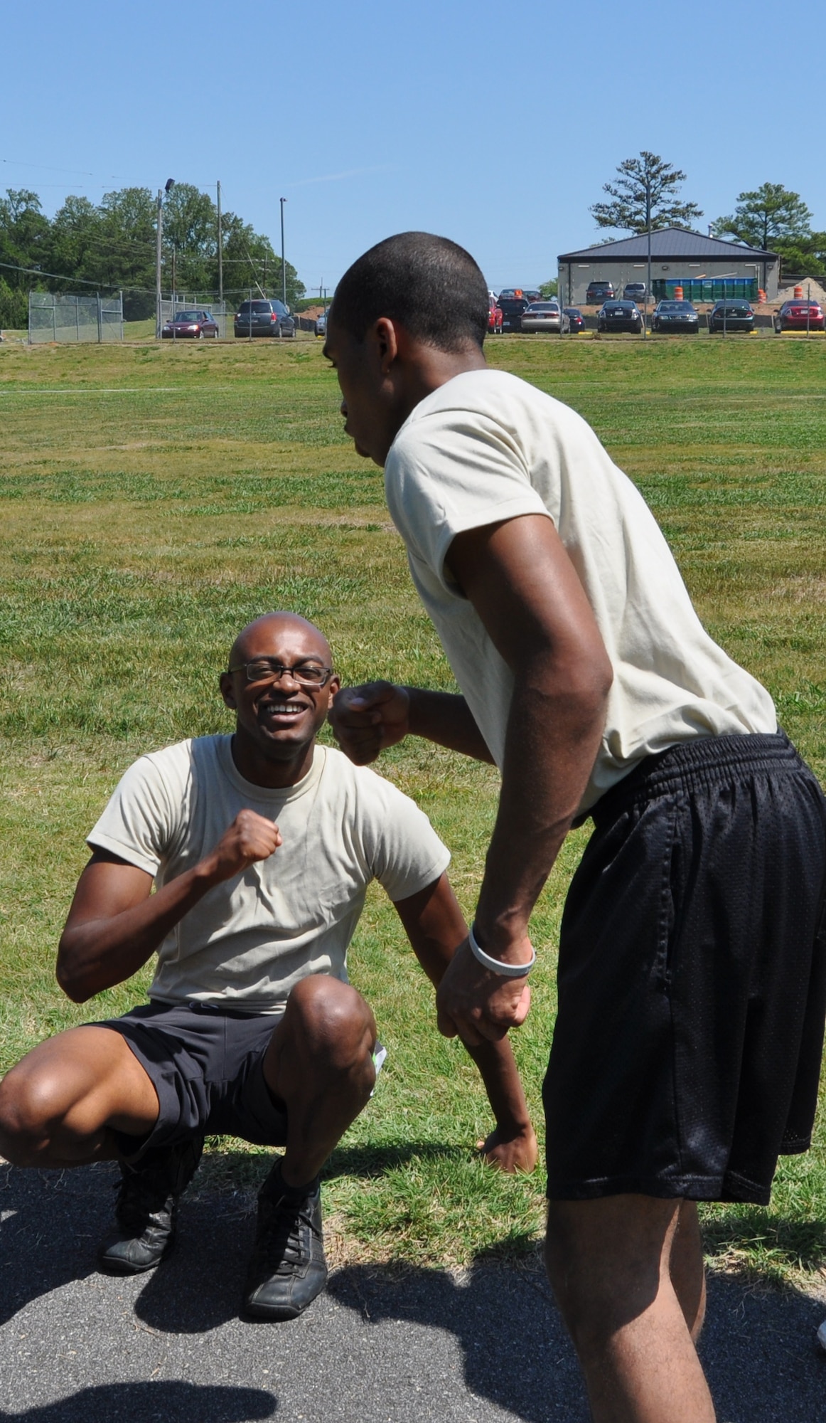 A Developmental and Training Flight, or D&TF, recruit congratulates his partner for completing sit-ups during the physical conditioning session. The D&TF prepares future airman for the challenges of basic military training. (U.S. Air Force photo/Senior Airman Chelsea Smith).