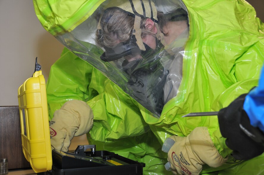 Airman 1st class Alexandria Mundstock, 183rd Fighter Wing, Springfield, Ill., emergency management, takes a sample of a chemical agent during an EM training exercise at Volk Field Combat Readiness Training Center April 14.  Mundstock joined Airmen from the 115th FW, Madison, Wis., and the 148th FW, Duluth, Minn., as the EM unit members trained together for the first time. (U.S. Air Force photo by Senior Airman Ryan Roth)
