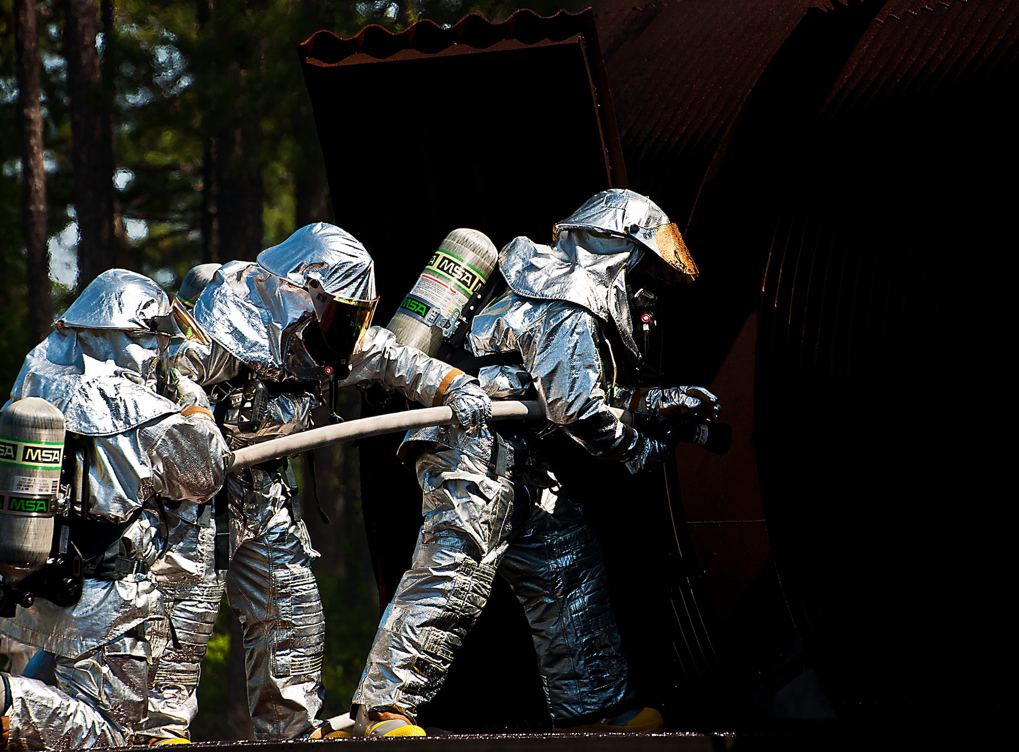 A team of firefighters from the 919th Special Operations Wing prepare to enter the aircraft during a fire exercise and training scenario at Hurlburt Field, Fla., April 13.  More than 10 of Duke Field’s firemen braved the flames of the aircraft burn pit for this annual refresher training.  (U.S. Air Force photo/Tech. Sgt. Samuel King Jr.)