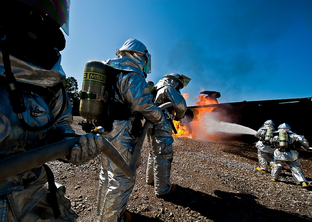 Teams of firefighters from the 919th Special Operations Wing fight a blaze on an aircraft engine during a fire training scenario at Hurlburt Field, Fla., April 13.  More than 10 of Duke Field’s firemen braved the flames of the aircraft burn pit for this annual refresher training.  (U.S. Air Force photo/Tech. Sgt. Samuel King Jr.)