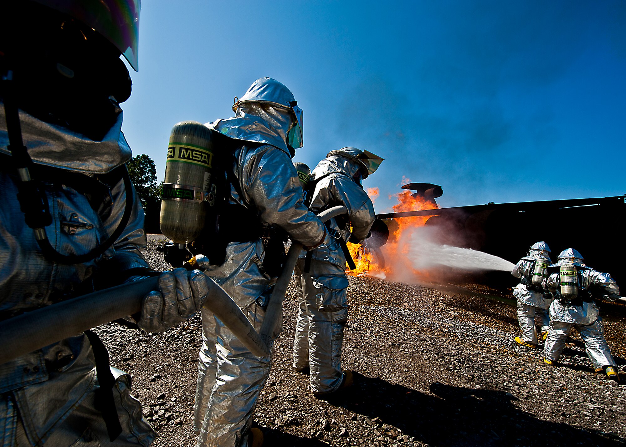 Teams of firefighters from the 919th Special Operations Wing fight a blaze on an aircraft engine during a fire training scenario at Hurlburt Field, Fla., April 13.  More than 10 of Duke Field’s firemen braved the flames of the aircraft burn pit for this annual refresher training.  (U.S. Air Force photo/Tech. Sgt. Samuel King Jr.)