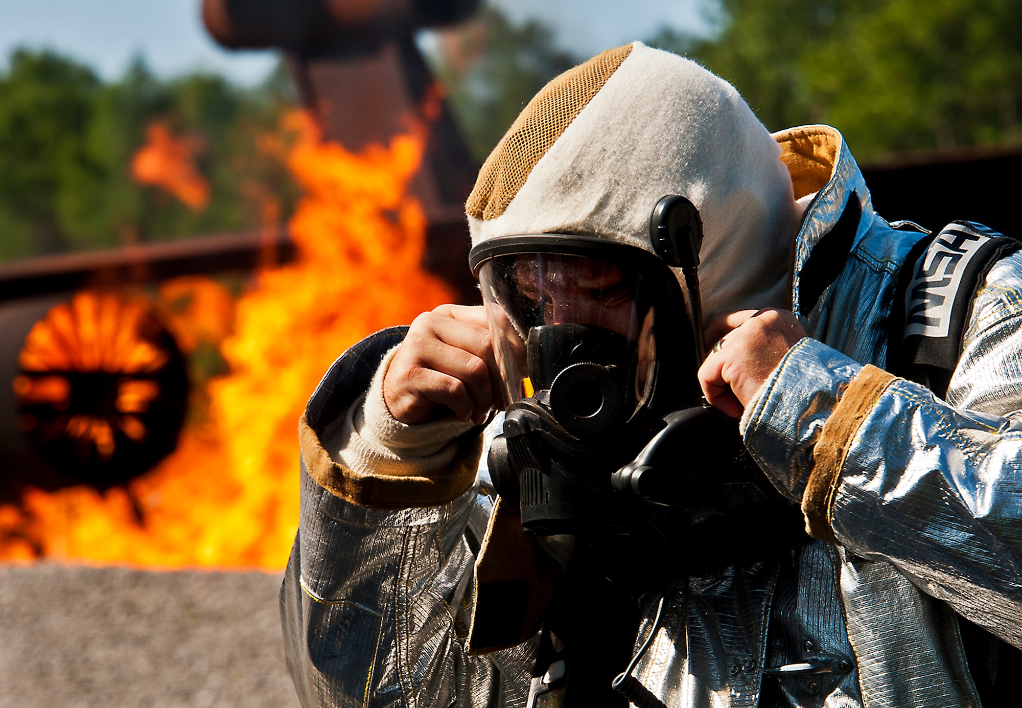 Tech. Sgt. Steve Waltermon, a 919th Special Operations Wing firefighter, adjusts his gas mask prior to battling a blaze during an aircraft fire training scenario at Hurlburt Field, Fla., April 13.  More than 10 of Duke Field’s firemen braved the flames of the aircraft burn pit for this annual refresher training.  (U.S. Air Force photo/Tech. Sgt. Samuel King Jr.)