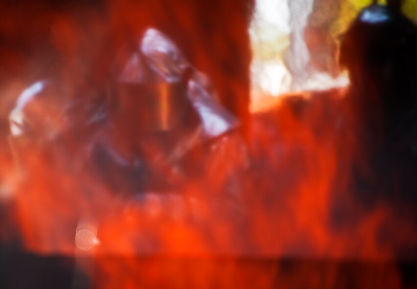 Firefighters, from the 919th Special Operations Wing, fight a blaze inside the aircraft during a fire training scenario at Hurlburt Field, Fla., April 13.  More than 10 of Duke Field’s firemen braved the flames of the aircraft burn pit for this annual refresher training.  (U.S. Air Force photo/Tech. Sgt. Samuel King Jr.)