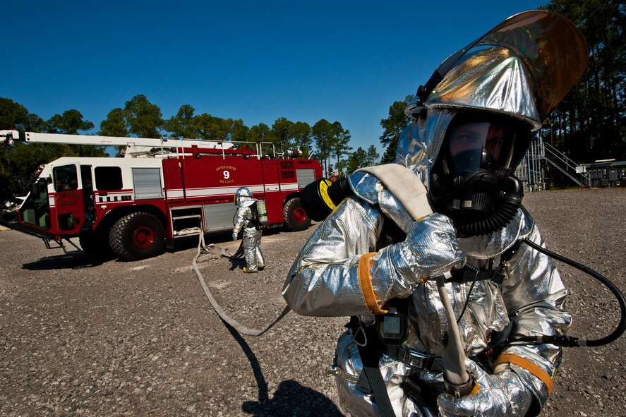 Staff Sgt. Gabriel Morgan, a 919th Special Operations Wing firefighter, extends the hose from fire truck prior to an aircraft fire exercise and training at Hurlburt Field, Fla., April 13.  More than 10 of Duke Field’s firemen braved the flames of the aircraft burn pit for this annual refresher training.  (U.S. Air Force photo/Tech. Sgt. Samuel King Jr.)