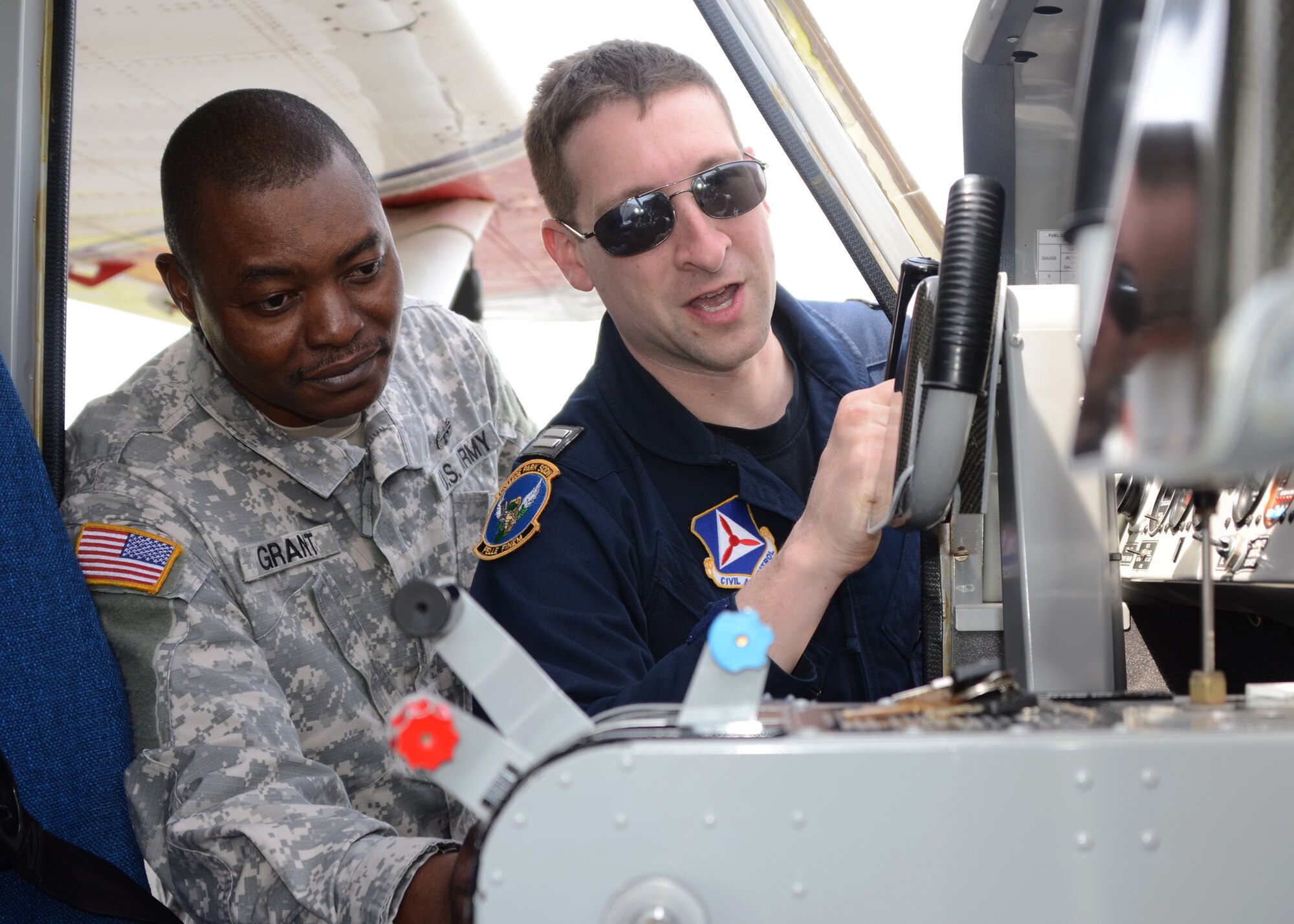 CAP Capt. Jonathan Neumann, a pilot with the Maryland Wing Civil Air Patrol, shows U.S. Army Sgt. 1st Class Matthew J.Grant, Maryland Army National Guard, the controls of a GA-8 aircraft at Warfield Air National Guard Base, Baltimore, MD on April 14, 2012. Members of the Maryland Air and Army National Guard work with the CAP, trained on the Geospatial Information Interoperability Exploitation-Portable system that gives incident commanders on the ground real time images in emergency situations. (National Guard Photo By Staff Sgt. Benjamin Hughes/RELEASED)