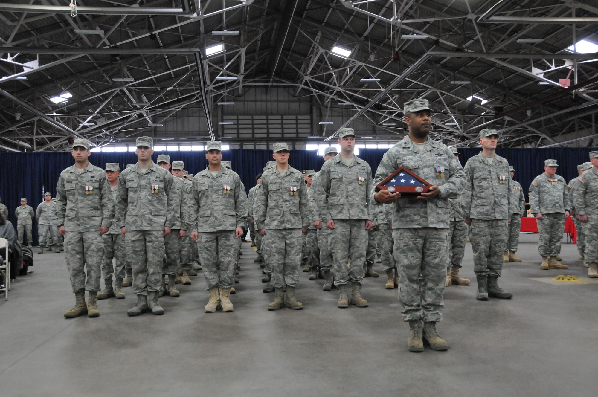 Col. Christopher Walker of the 103rd Air Operations Group stands as Commander of Troops with fellow Connecticut Air National Guardsmen during a formal Joint Freedom Salute Ceremony in the main hangar at Bradley Air National Guard Base in East Granby, Conn. March 31, 2012. Airmen and Soldiers of the Connecticut National Guard were formally welcomed home and honored following deployments over the past year. (U.S. Air Force photo by Tech. Sgt. Erin McNamara\RELEASED)