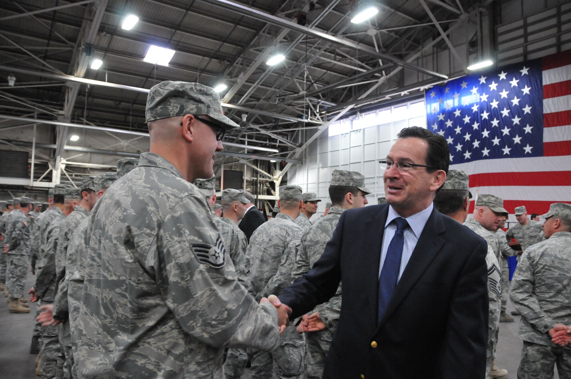 Connecticut Governor Dannel P. Malloy congratulates and thanks Staff Sgt. Derek Egerman of the 103rd Civil Engineer Squadron for his service following a formal Joint Freedom Salute Ceremony in the main hangar at Bradley Air National Guard Base in East Granby, Conn. March 31, 2012. Airmen and Soldiers of the Connecticut National Guard were formally welcomed home and honored following deployments over the past year. (U.S. Air Force photo by Tech. Sgt. Erin McNamara\RELEASED)