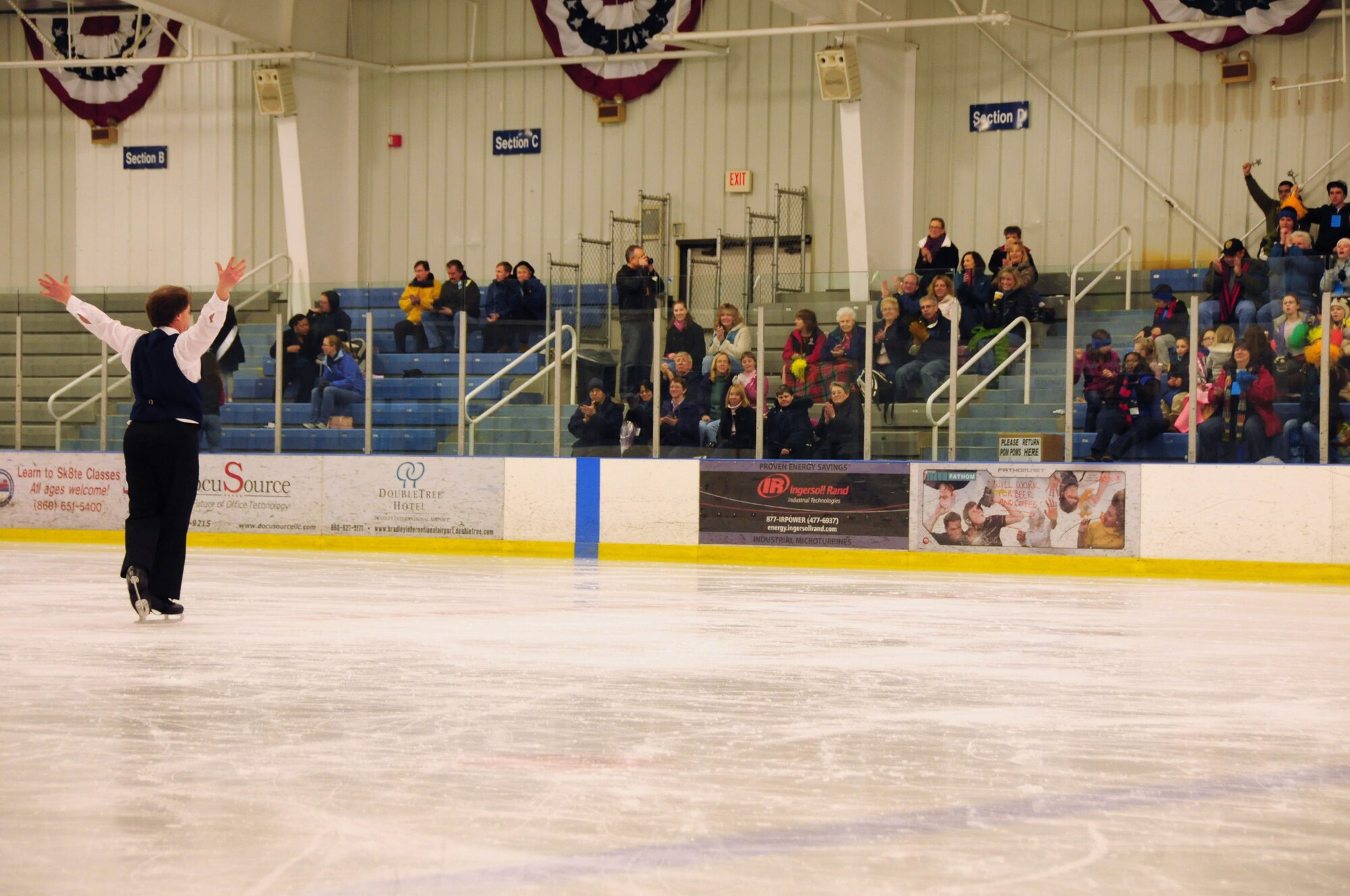 Michael Finlay of Boston Mass., welcomes applause from the crowd during the Special Olympics March 4, 2012. Finlay was one of many athletes who took part in the figure skating event at the international skating center in Simsbury, Conn. Several members of the Connecticut Air National Guard volunteered to help staff the event. (U.S. Air Force photo by Airmen 1st Class Emmanuel Santi-ago/Released)