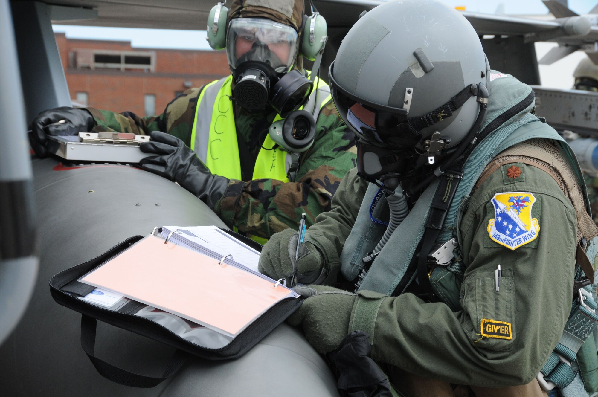 Members of the 148th Fighter Wing participate in an Operational Readiness Exercise June 11, 2011. The exercise was designed to refamiliarize Airmen with Force Protection Conditions, Mission Oriented Protection Postures and for members to perform the mission while wearing the Chemical Protective Overgarment. (U.S. Air Force photo by Senior Airman Sarah Hayes.)