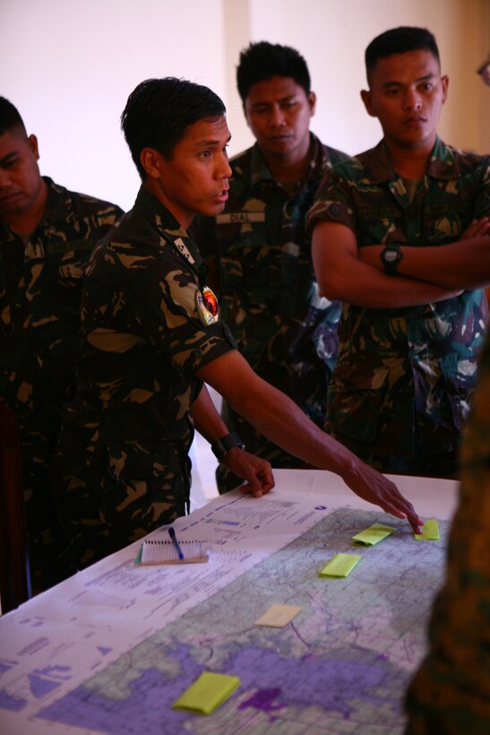 Armed Forces of the Philippines 1st Lt. Aminkadra B. Abdula points at a map, while AFP Airman 1st Class Roman P. Dial and Airman 1st Class Madrhar M. Jabbar listen during a convoy operations class on Antonio Bautista Air Base in Puerto Princesa, April 16, 2012 for Exercise Balikatan 2012. The class educated a group of Philippine airmen and was instructed by U.S. Marine Capt. Max Foti and U.S. Marine Staff Sgt. Jorge A. Gonzalezmancha from Marine Wing Support Squadron 172. BK12 is a bilateral, joint exercise conducted annually between the Republic of the Philippines and U.S. military members. Abdula is the squadron commander of 5715th Motor Vehicle Squadron, Philippine Air Force. MWSS-172 is with Marine Wing Support Group 17, 1st Marine Aircraft Wing, III Marine Expeditionary Force.