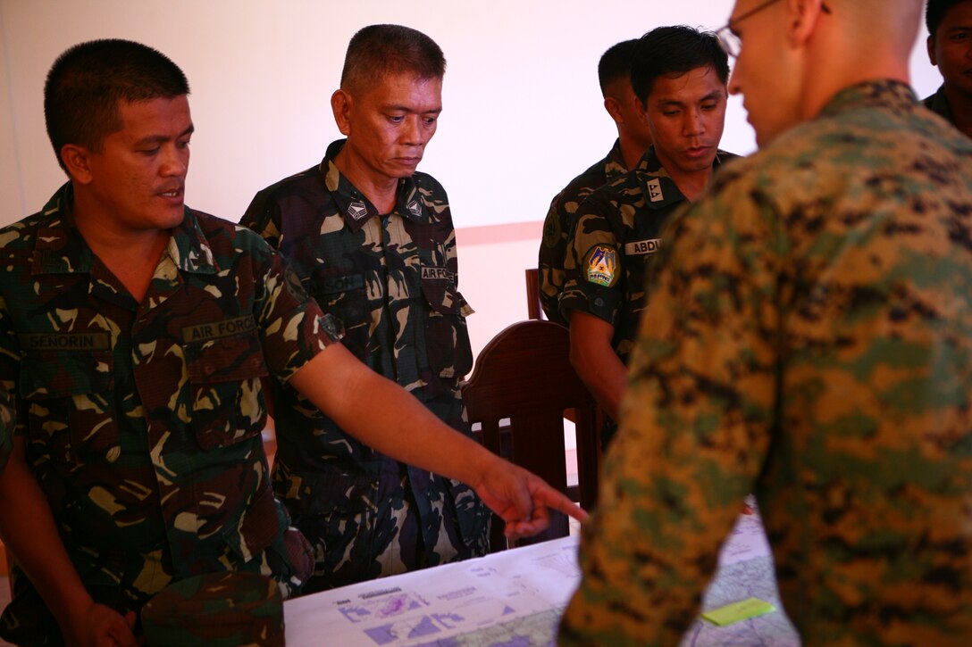 Armed Forces of the Philippines Airmen 1st Class Peter J. V. Senorin asks questions to U.S. Marine Capt. Max Foti, while Tech. Sgt. Federico C. Samson and 1st Lt. Aminkadra B. Abdula listen during a convoy operations class on Antonio Bautista Air Base in Puerto Princesa, April 16, 2012 for Exercise Balikatan 2012. The class educated a group of Philippine airmen and was instructed by two U.S. Marines from Marine Wing Support Squadron 172. BK12, in its 28th iteration, is a bilateral, joint exercise conducted annually between the Republic of the Philippines and U.S. military members. Senorin is a vehicle operator with 5715th Motor Vehicle Squadron, Philippine Air Force. MWSS-172 is with Marine Wing Support Group 17, 1st Marine Aircraft Wing, III Marine Expeditionary Force.