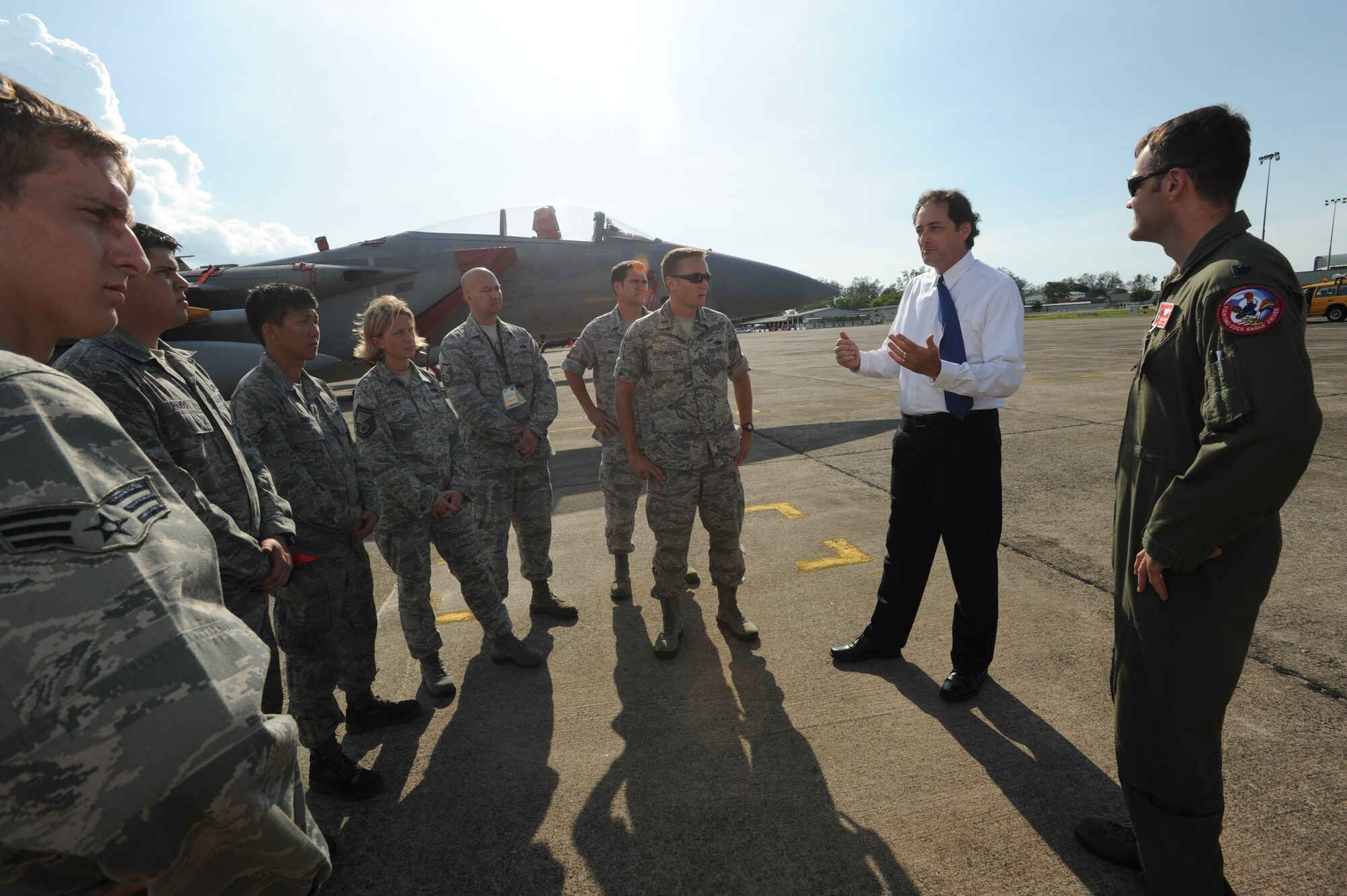 Lee McClenny, Deputy Chief of Mission at the U.S. Embassy in Kuala Lumpur, talks with Airmen from the 67th Fighter Squadron and 67th Aircraft Maintenance Unit, following the closing ceremony of Cope Taufan 2012 at TUDM Butterworth April 13, 2012. Cope Taufan is a live-flying exercise designed around dissimilar basic fighter maneuvers and dissimilar air combat tactics training between the U.S. Air Force and Royal Malaysian Air Force. (U.S. Air Force photo/Master Sgt. Matt Summers) 