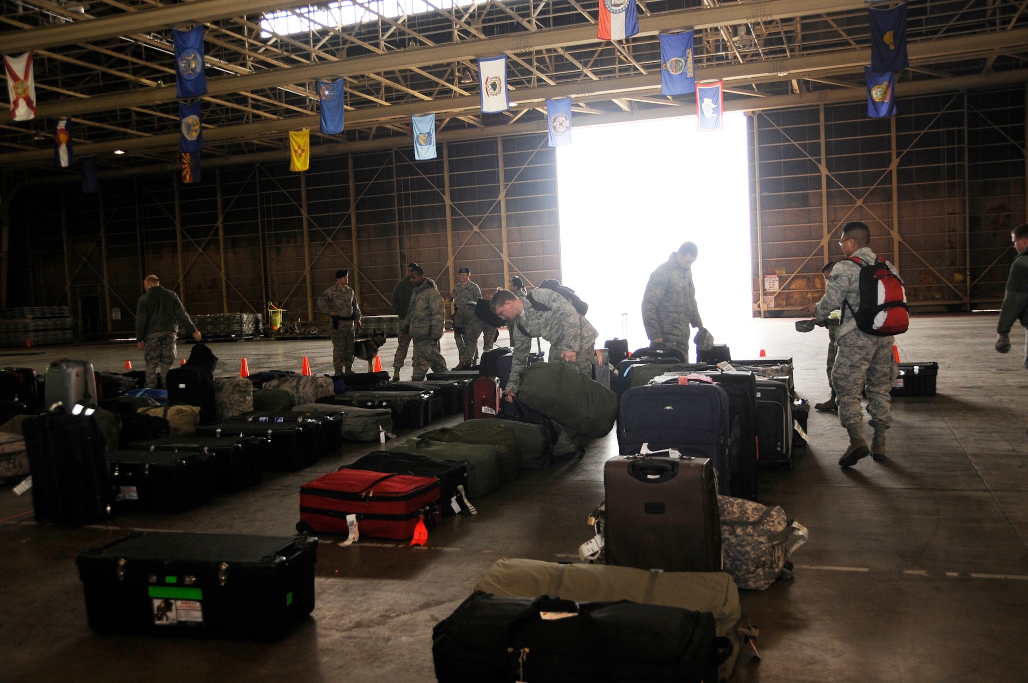 U.S. Air Force Airmen from the 13th and 14th Fighter Squadrons and Aircraft Maintenance Units claim their luggage after returning home from Operation Noble Eagle at Misawa Air Base, Japan, April 15, 2012. Airmen from the 13 and 14 FS and AMU supported the Alaskan North American Aerospace Defense Command during the deployment. (U.S. Air Force photo by Airman 1st Class Kia Atkins/Released)
