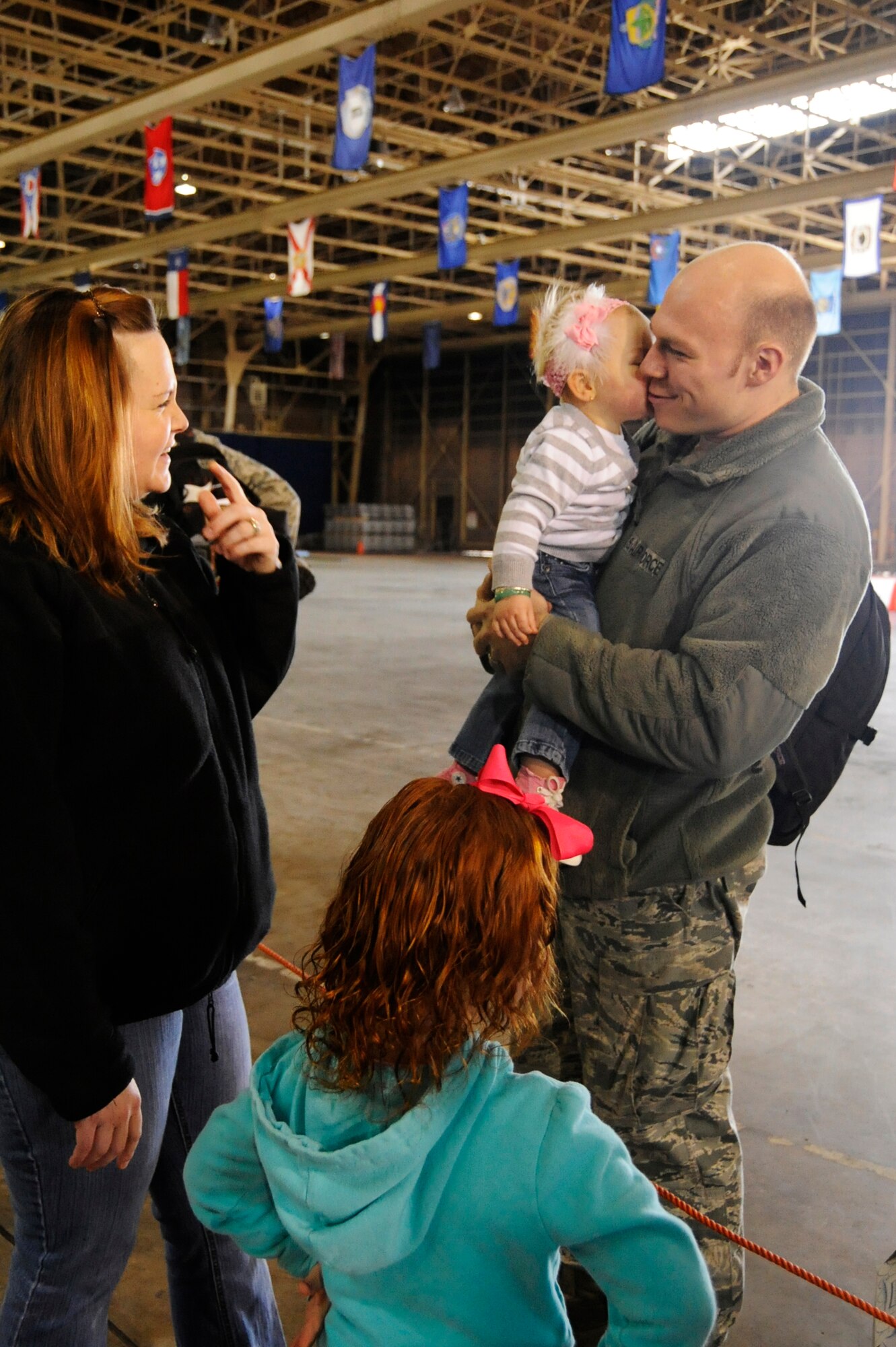 U.S. Air Force Staff Sgt. Martin DeBardeleben, 35th Aircraft Maintenance Squadron engine specialist, is welcomed home by his family at Misawa Air Base, Japan, April 15, 2012. Airmen from the 13th and 14th Fighter Squadrons and Aircraft Maintenance Units returned to Misawa after being deployed to Alaska for approximately nine-months in support of Operation Noble Eagle. (U.S. Air Force photo by Airman 1st Class Kia Atkins/Released)
