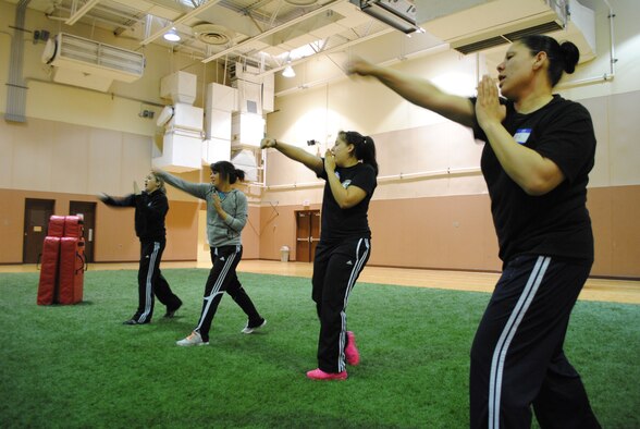 MALMSTROM AIR FORCE BASE, Mont. - From left, Airman 1st Class Alyssa Larson, 741st Missile Security Forces Squadron mobile fire team member; Senior Airman Mary Tarasiewicz, 741st MSFS unit fitness program manager; Airman 1st Class Jannet Uribe, 741st MSFS mobile fire team member; and Staff Sgt. Alma Torres, 741st MSFS mobile fire team leader, practice a punching move during a Rape Aggression Defense class at the Malmstrom Air Force Base Fitness Center April 6. (U.S. Air Force photo/Airman 1st Class Katrina Heikkinen) 