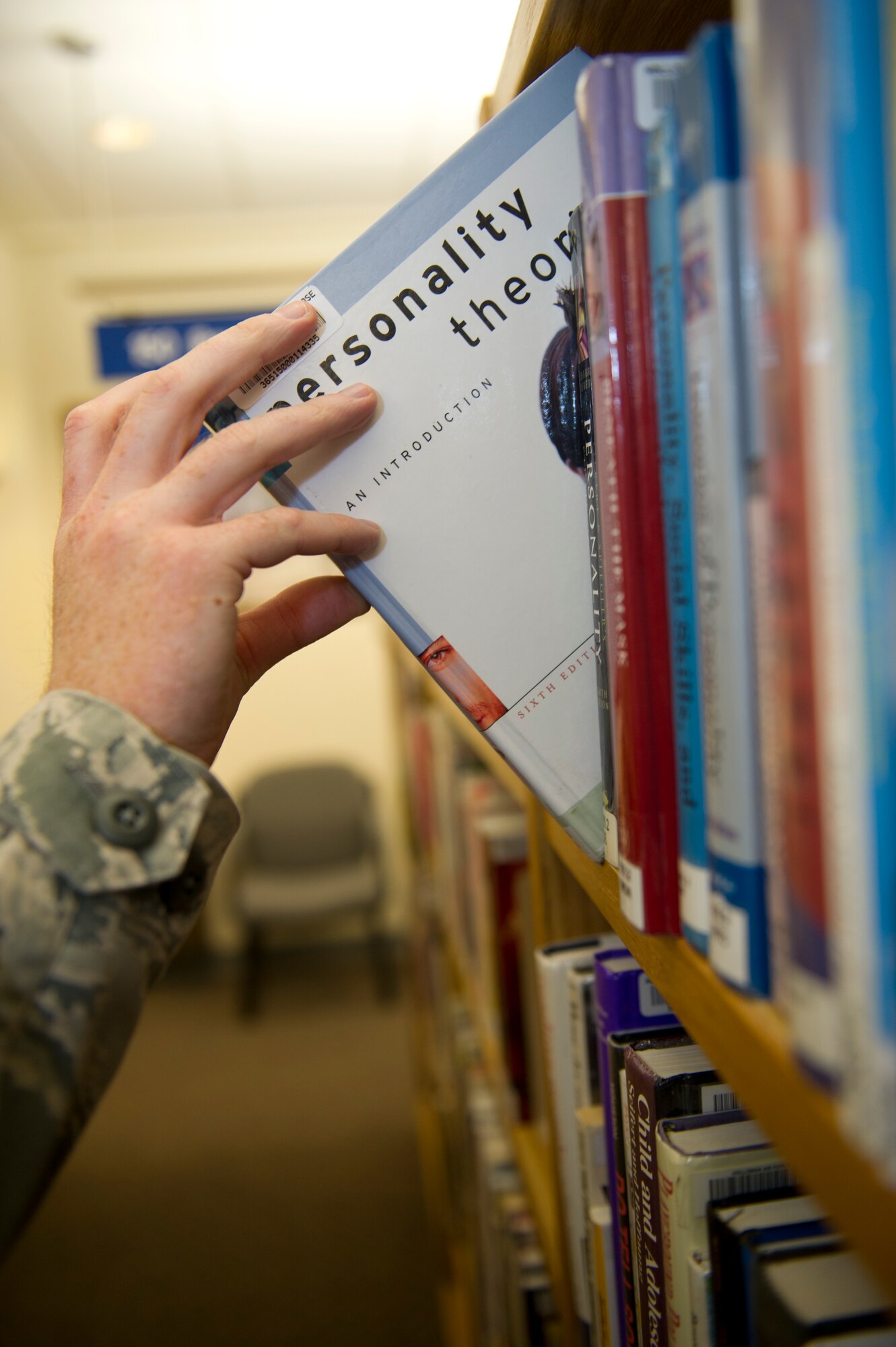 HOLLOMAN AIR FORCE BASE, N.M. – An Airman takes a book from the shelf at the Ahrens Memorial Libarary March 1. The library offers a variety of learning tools to boost morale and support education on base. (U.S. Air Force photo by Airman 1st Class Daniel E. Liddicoet/Released)