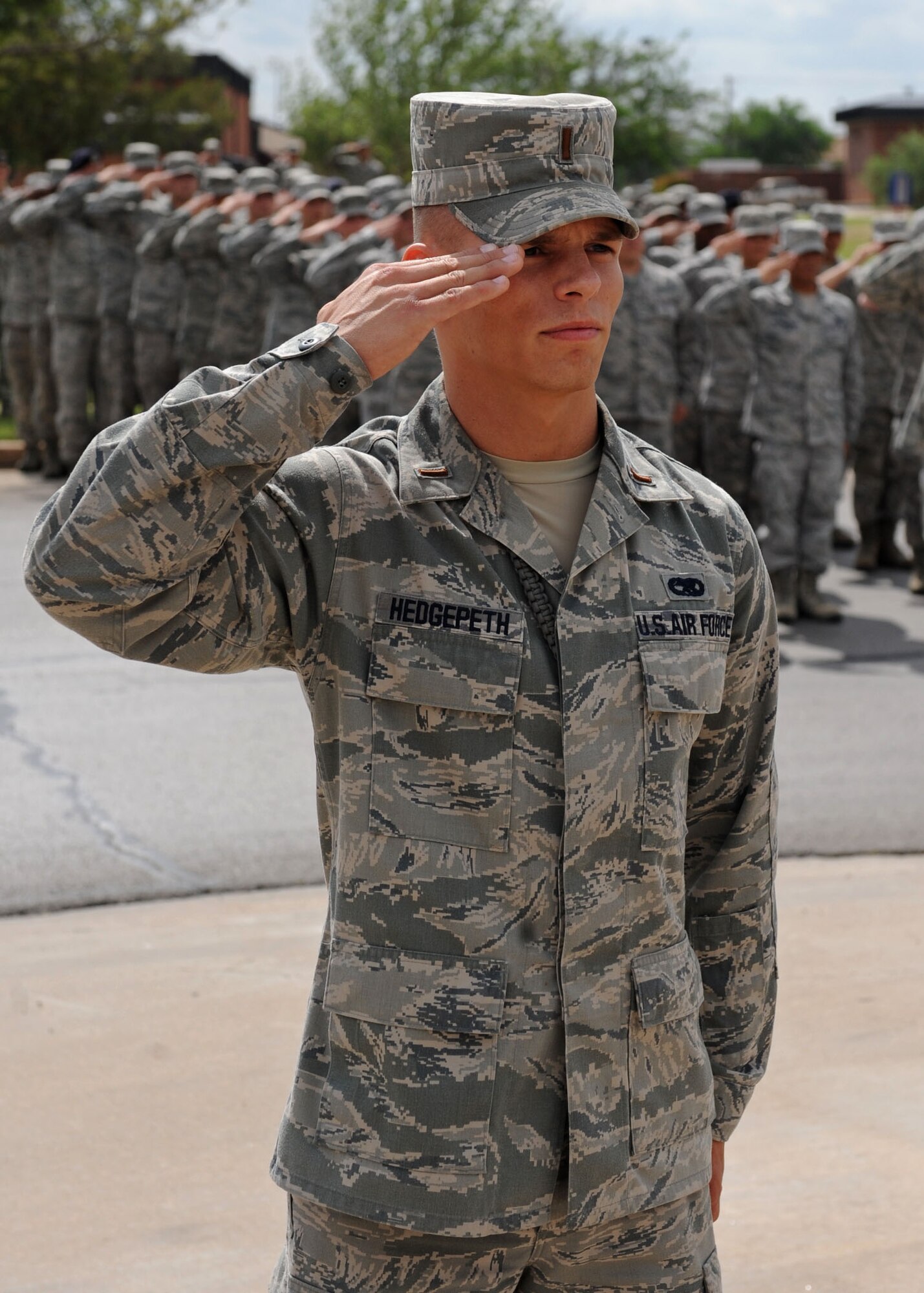 U.S. Air Force 2nd Lt. James Hedgepeth, 7th Component Maintenance Squadron, renders a salute as the American flag is retrieved during a wing retreat ceremony April 13, 2012, at Dyess Air Force Base, Texas. A retreat ceremony signifies the end of a duty day and is also a way to pay tribute to the American flag. (U.S. Air Force photo by Airman 1st Class Peter Thompson/ Released)