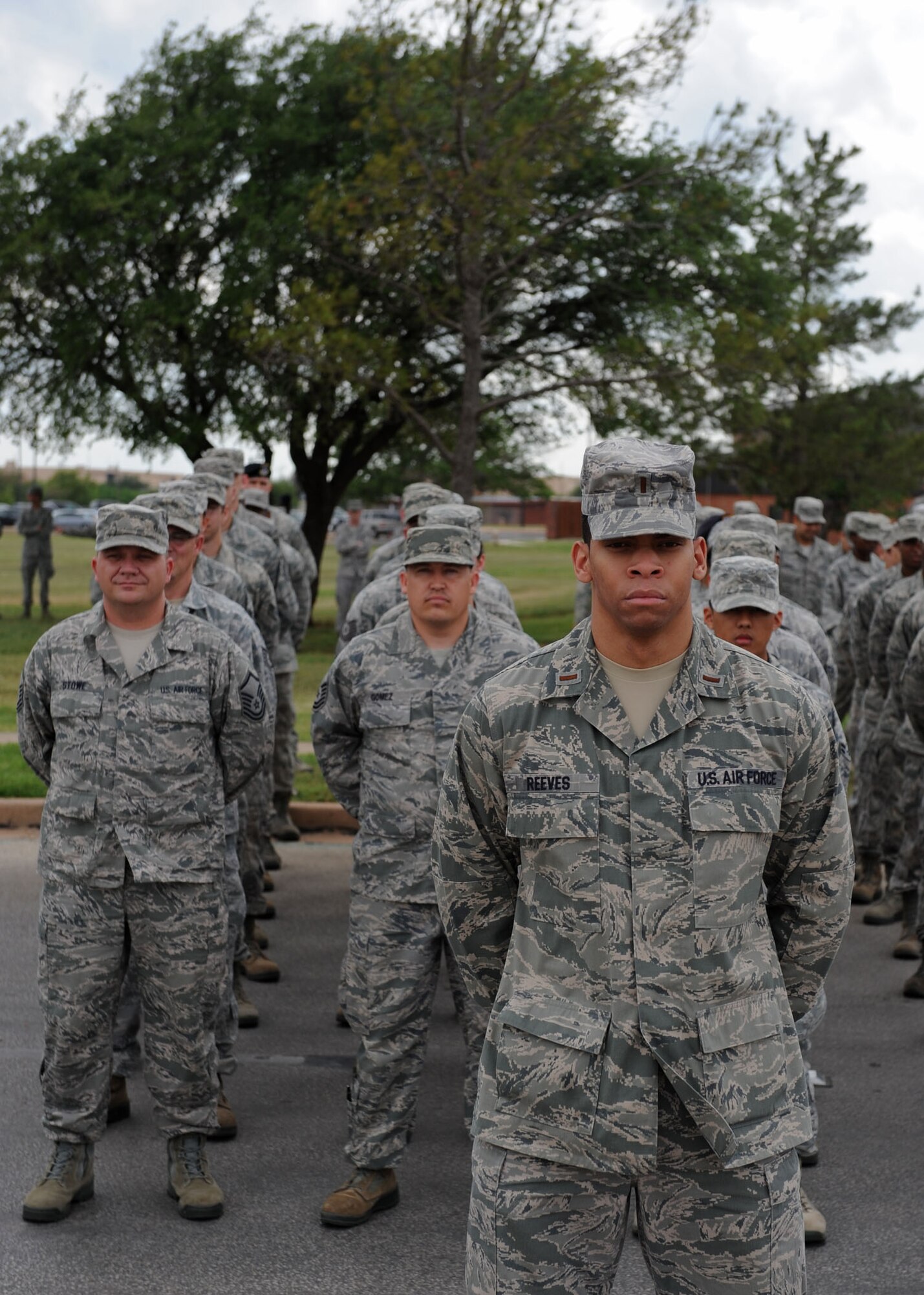 U.S. Air Force 2nd Lt. David Reeves, 7th Force Support Squadron, stands in front of a flight of airmen from the 7th Mission Support Group during a wing retreat ceremony April 13, 2012, at Dyess Air Force Base, Texas. A retreat ceremony signifies the end of a duty day and is also a way to pay tribute to the American flag. (U.S. Air Force photo by Airman 1st Class Peter Thompson/ Released)