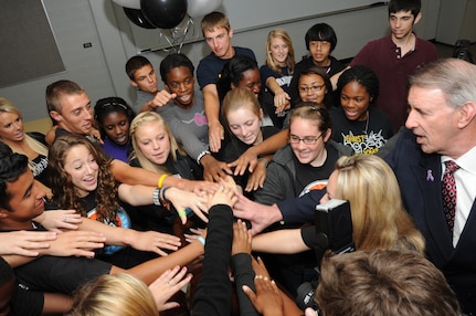 The Randolph High School Student Council puts their hands in to do a final cheer April 13 after being awarded a $20,000 check by San Antonio Spurs representatives. The student council was selected for their DriveSMART campaign by the Silver and Black Give Back’s Team Up Challenge. (U.S. Air Force photo by Melissa Peterson)